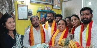 KRV Simha Sene activists honoring CMC G. Amrutha with a silk saree and traditional plate