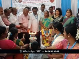 CMC Commissioner Amrutha and BJP leader Ramachandra Gowda distributing health cards to workers