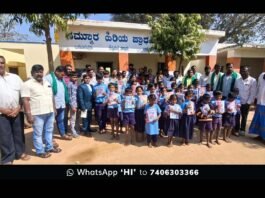 Family of Late Chetan and Farmer leaders distributing items to smiling school children