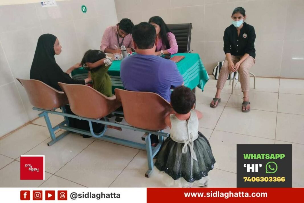 Doctors from St Johns Medical College counselling a family during a free developmental screening camp at Sidlaghatta government hospital
