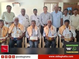 CHIMUL director Bunk Muniyappa and officials with dairy farmers and retired society secretaries receiving cattle insurance and honorarium cheques